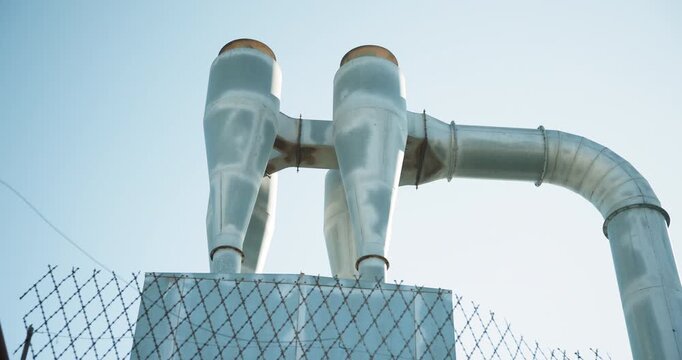 Industrial, factory and cyclone extractor outdoor for air filtration, dust collection and processing. Manufacturing facility, ventilation pipes and separator for pollution control, plant or exterior