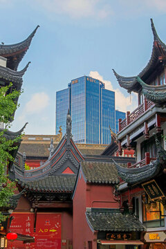  Historic temple roofs of the old town (Nanshi) creating a striking contrast with the modern Bund Finance Center (BFC) headquarter building rising above the city, Shanghai, China, 31 July 2026
