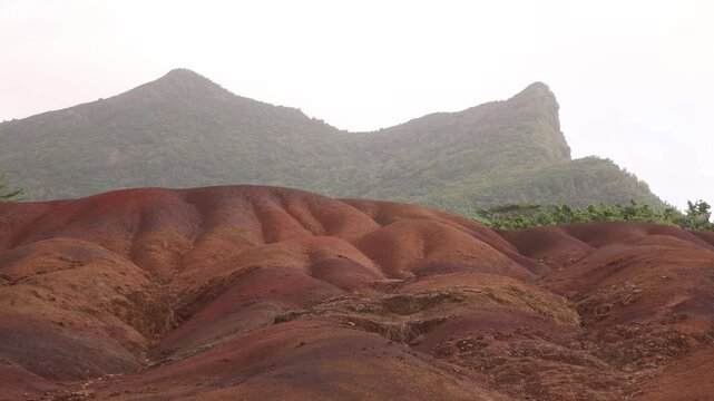Panoramic view of the vibrant multi-colored sand dunes and mineral-rich hills at Chamarel Seven Coloured Earth geopark in Mauritius