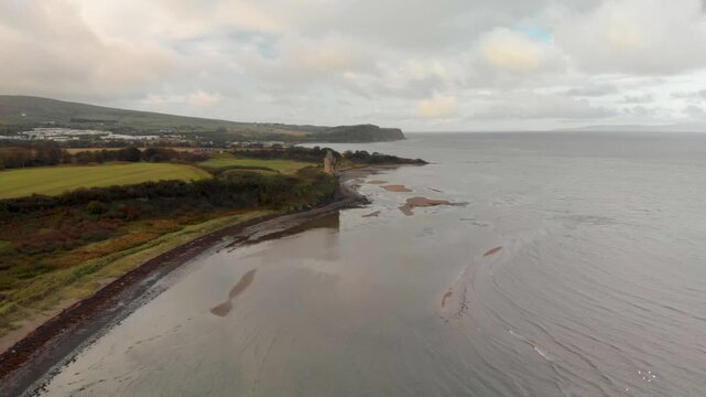 Greenan Castle ruins on cliff with Heads of Ayr headland beyond, Ayrshire.