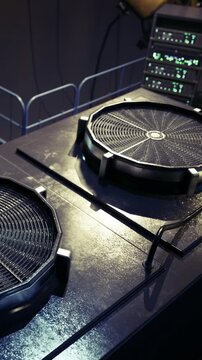 Two sleek turntables sit ready in a modern music studio, surrounded by glowing equipment. The atmosphere pulses with creativity and anticipation for the next track to be mixed.