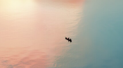 Fototapeta premium Horizontal aerial view of a small canoe with two people on calm pastel colored water with large copy space