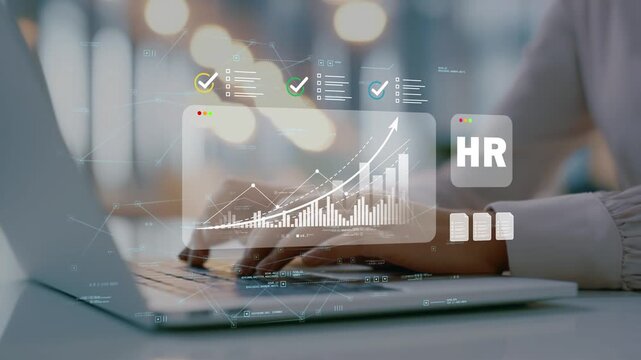 Female business professional working on laptop in modern office using human capital management and organizational development initiatives supported by workforce analytics chart insights