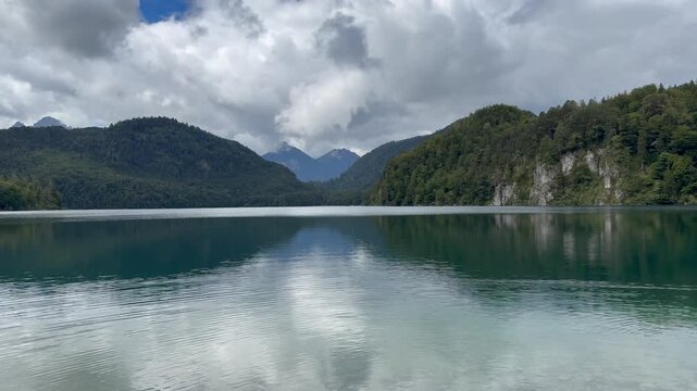 Alpsee Lake at Hohenschwangau town. Hike to Neuschwanstein castle starts here. Motion of water. Alpsee, Bavaria, Germany