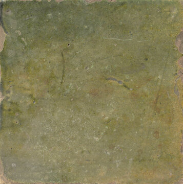 Weathered antique green glazed ceramic tile texture with scratches, stains, and rustic chipped edges for vintage backgrounds