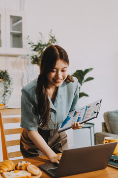 Young adult asian business woman using laptop chat digital artificial intelligence assistance ai chatbot prompt analysis work modern lifestyles