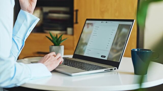 Person booking accommodation online using laptop at home desk.