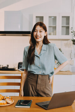 Young adult asian business woman using laptop chat digital artificial intelligence assistance ai chatbot prompt analysis work modern lifestyles