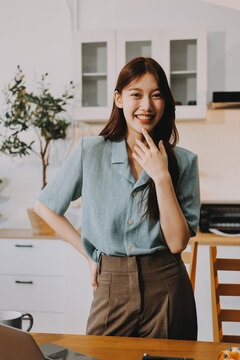 Young adult asian business woman using laptop chat digital artificial intelligence assistance ai chatbot prompt analysis work modern lifestyles