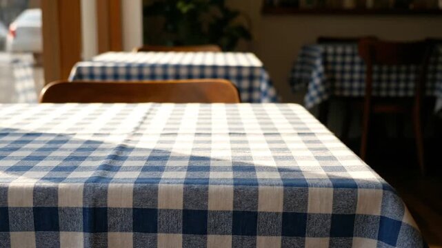 Cafe tables with checkered tablecloths.