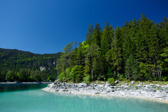 Travel landscape of Zugspitze Alps in Bavaria Germany, scenic summer nature panorama with forest, Eibsee lake. Alpine landscape
