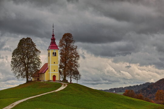 Undulating dirt trail going uphill to the Baroque, XVII c.Saint Thomas church (Cerkev svetega Tomaza) in Gorenji Vrsnik village. Idrija-Slovenia-192