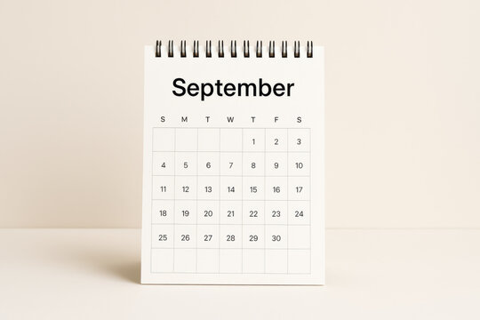 Minimalist calendar page turned to September with clean design on neutral background, perfect for planning and organizing monthly schedule in simple workspace environment
