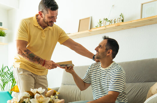 Gay men sharing a book at home