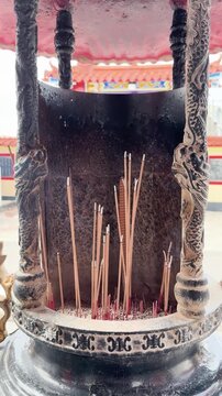 Burning Incense Sticks in Traditional Temple Incense Burner