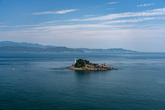 Tobishima Island with a white lighthouse floating in the Naruto Strait.