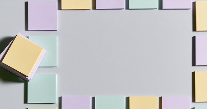 Pastel sticky notes form a light-colored frame on a pale background