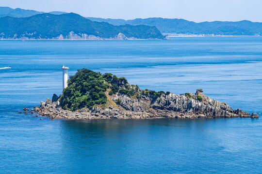 Tobishima Island with a white lighthouse floating in the Naruto Strait.
