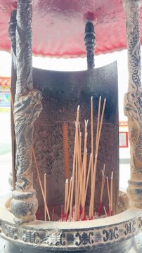 Burning Incense Sticks in Traditional Temple Incense Burner