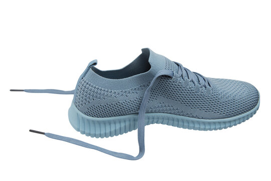 Women dusty blue flyknit sport sneaker isolated on white background. Casual breathable running shoe with untied laces, side view.