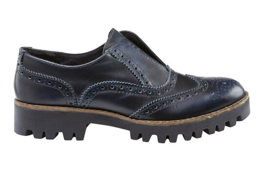 Women navy blue leather chunky platform brogues isolated on white background. Casual wingtip slip-on shoes with tractor sole, side view.
