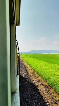 Salatiga, Central Java / Indonesia - May 29 2025: High-quality 1080p 60fps footage of the tourist train ride from Ambarawa to Rawa Pening across beautiful rural rice paddies.
