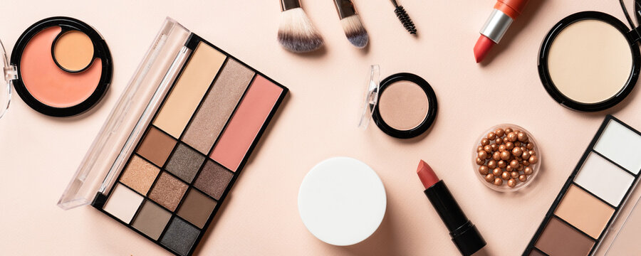 Make up products. Shadow palette with brushes, lipstick, cream and others.