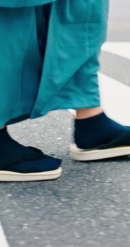 Man, walk and shoes with crosswalk, traditional outfit and sandals for heritage or summer fashion. Japanese person, zori and steps for trip, culture and travel with casual kimono or yukata in city