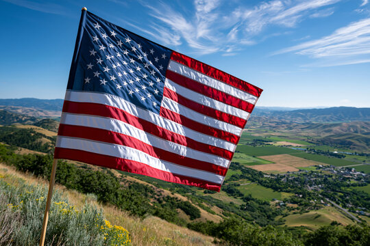Large United States flag waving over a scenic countryside horizon, bright summer day, expansive sky, inspiring patriotic theme