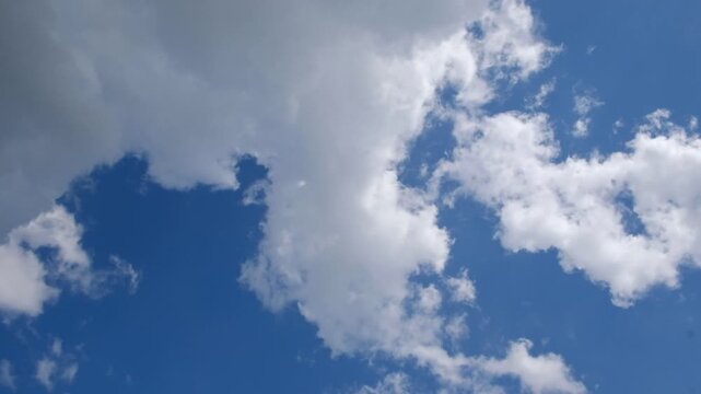 Blue sky with scattered white clouds, a clean natural background for weather, freedom, travel, and environmental concepts.