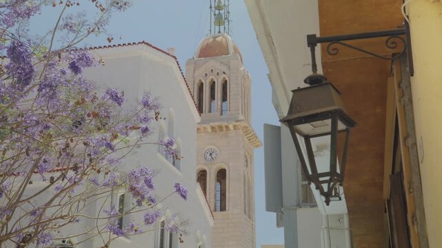 Rethymno Cathedral bell tower, Crete, Greece, Jacaranda tree and street lamp
