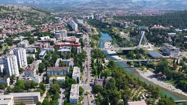 Aerial drone view of the capital city Podgorica in Montenegro, with the bell towers of the Orthodox Temple of Christ's Resurrection and the Millennium Bridge. Architecture of a Balkan city in Europe.