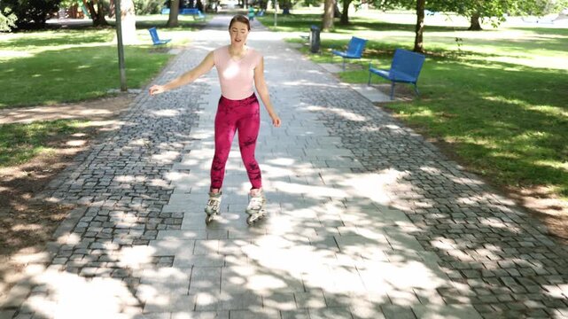 Woman enjoys a relaxed inline skating workout in a sunny park smiling while practicing smooth movements improving balance and staying active outdoors every day