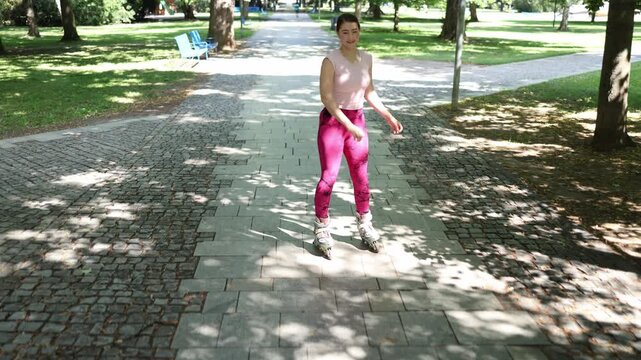 Woman smiles with relief after successfully making her first gentle downhill ride on inline skates gaining confidence and enjoying early progress as a beginner