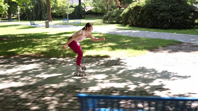 Woman accelerates on inline skates during training building speed refining technique and improving endurance with a powerful outdoor skating workout