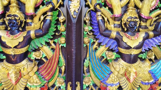 Detailed close up shot of a golden bhudist temple door in Thailand