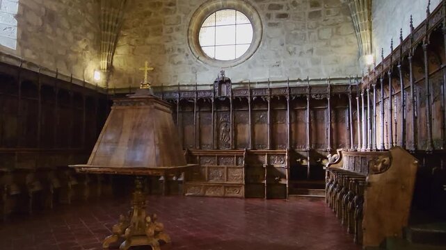 Choir stalls and medieval lectern of the Monastery of Yuste. 16th-century wood-carved choir stalls. Stand for medieval incunabula books. Monastery of San Jer&oacute;nimo de Yuste. Spain.