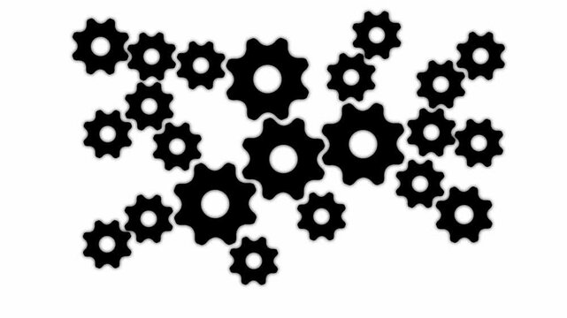 A collection of various sized black gear arranged in a cluster on a white background representing mechanical engineering and industrial systems