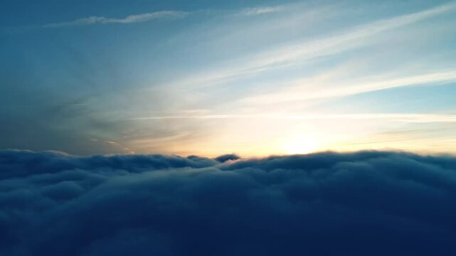 Sunrise Above the Clouds: Aerial View of Golden Light Breaking Through Fluffy Cloud Sea
