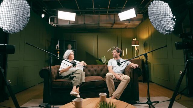 Media personalities having a conversation during a podcast recording. The scene reveals the behind the scenes setup of a modern studio