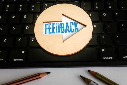 FEEDBACK Arrow on Computer Keyboard Beside Pencils in Office Workspace