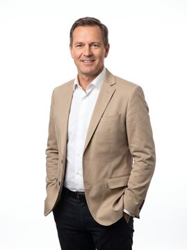 Confident Mature Businessman in Beige Blazer Standing Against White Background