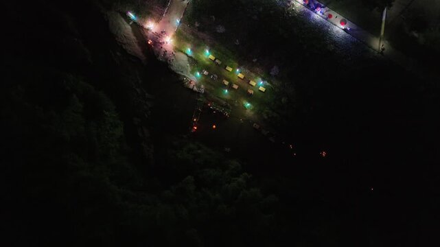 Topview of Wat Sri Kaew temple fair in Nong Bua Lamphu, Thailand. This unseen perspective reveals the authentic charm of Isan culture under the night sky.