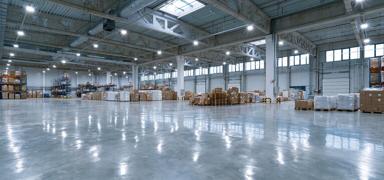 Bright industrial warehouse featuring high ceilings and polished floors, perfect for efficient storage and logistics.