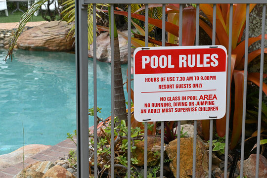 Sign on a pool fence showing the rules