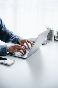 Close up of businessperson using laptop working with digital data