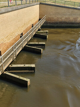 Water management and flood control at Sneum Sluse sluice gate doors Wadden Sea Coast Tjaereborg Denmark River water flows into the sea