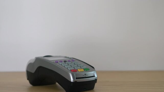 Credit card payment on modern wireless reader terminal for secure retail shopping transaction in 4K Ultra HD footage
