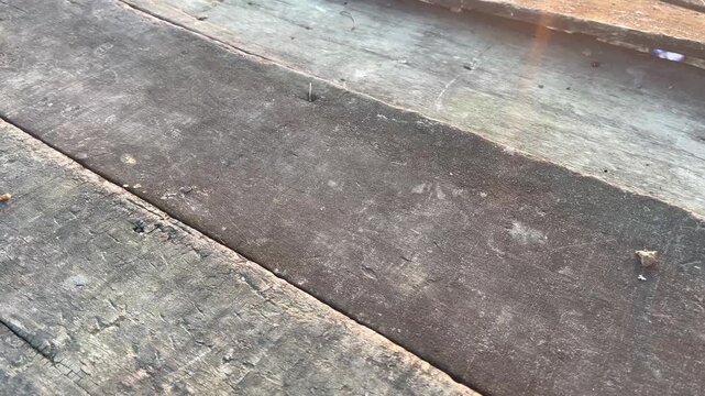 Aged Wooden Plank with Rusty Nail and Warm Sun Flare Effect