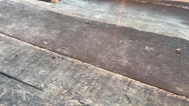 Aged Wooden Plank with Rusty Nail and Natural Sun Flare